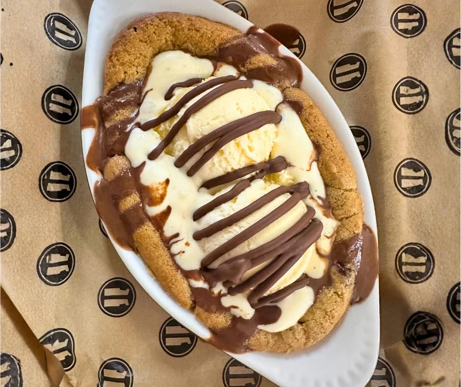 Cookie dessert with ice cream and chocolate drizzle at Arcade 11